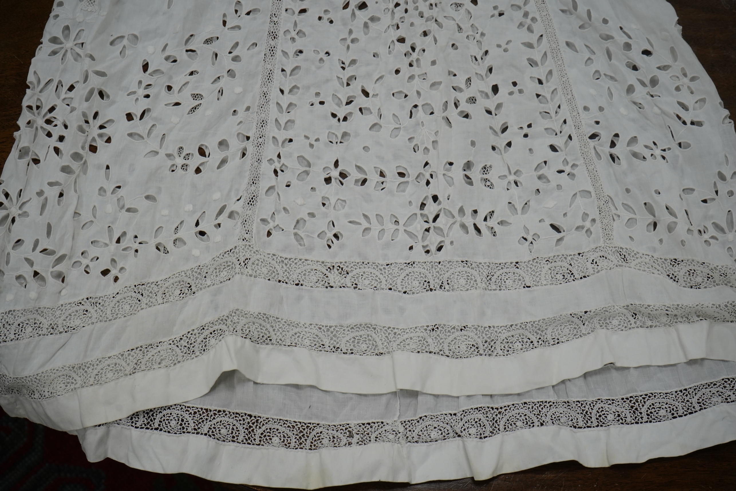 An Edwardian fine white embroidery anglaise and Irish crochet trimmed ladies summer dress, designed with large panels of anglaise cut work, the dress has been altered and restyled, which could be altered back, 134cm long